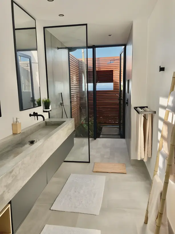 Bathroom with a poured concrete vanity and walk-in shower