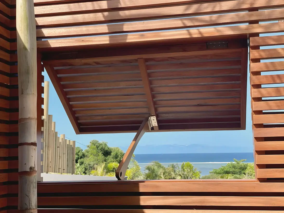 A slatted timber pergola framing the sea